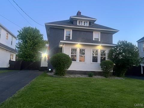 567 Grant Blvd, Syracuse, NY 13203 - traditional style home with a front lawn and a chimney