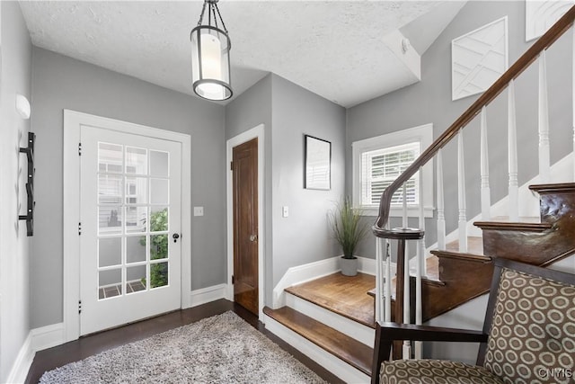 567 Grant Blvd, Syracuse, NY 13203 - entrance foyer featuring stairs, a textured ceiling, and wood finished floors