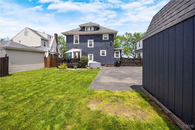 567 Grant Blvd, Syracuse, NY 13203 - back of house featuring a wooden deck, a patio, and a shingled roof
