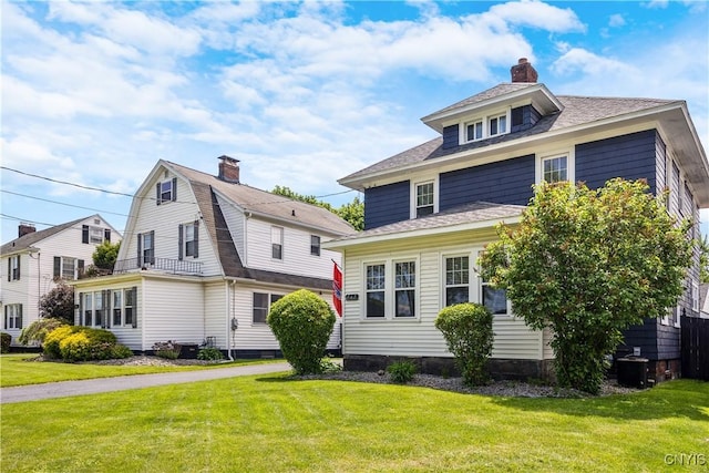 567 Grant Blvd, Syracuse, NY 13203 - view of front facade featuring a front yard, a chimney, and a shingled roof