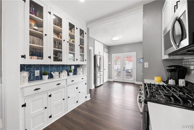 567 Grant Blvd, Syracuse, NY 13203 - kitchen with appliances with stainless steel finishes, french doors, dark wood-type flooring, white cabinetry, and glass insert cabinets
