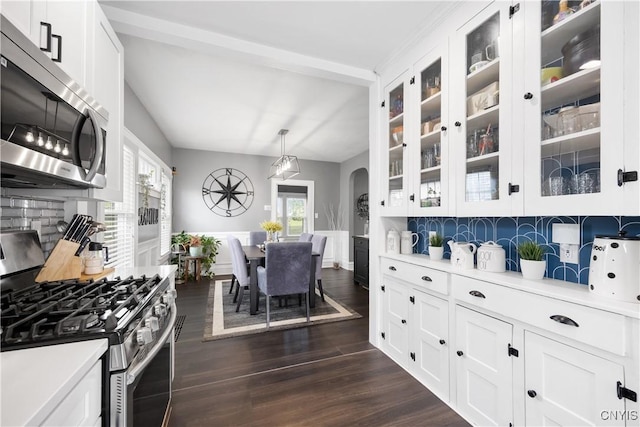 567 Grant Blvd, Syracuse, NY 13203 - kitchen featuring appliances with stainless steel finishes, light countertops, decorative backsplash, and white cabinetry