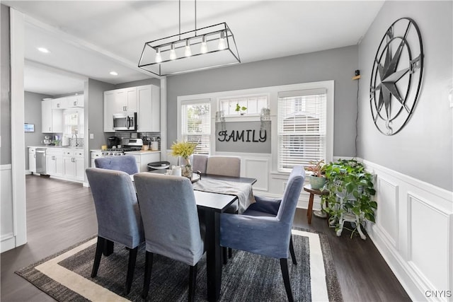 567 Grant Blvd, Syracuse, NY 13203 - dining area featuring dark wood-type flooring, recessed lighting, wainscoting, and a decorative wall