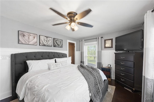 567 Grant Blvd, Syracuse, NY 13203 - bedroom with a wainscoted wall, ceiling fan, and dark wood-style flooring