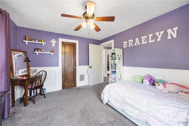 567 Grant Blvd, Syracuse, NY 13203 - bedroom with wainscoting, carpet, and ceiling fan