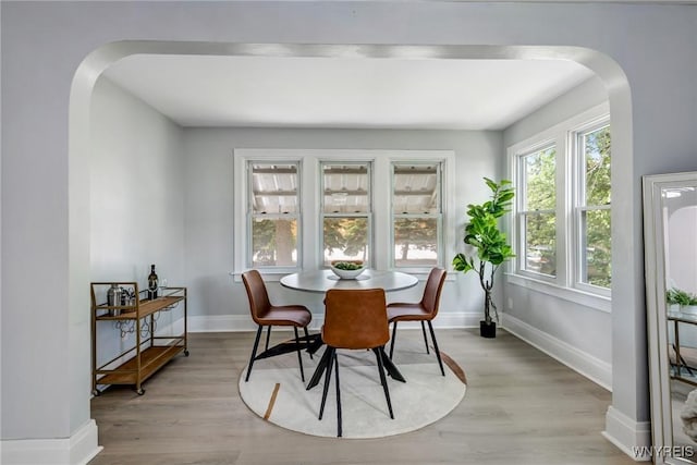 185 N Pleasant Pkwy, Cheektowaga, NY 14206 - dining room with arched walkways and light wood-style flooring