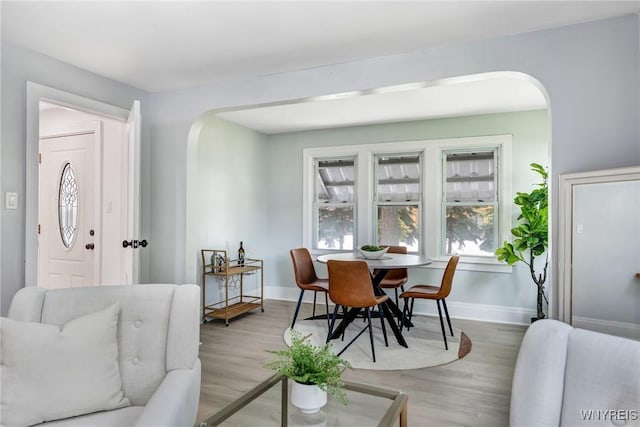 185 N Pleasant Pkwy, Cheektowaga, NY 14206 - dining area featuring arched walkways and light wood-style flooring
