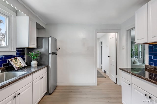 185 N Pleasant Pkwy, Cheektowaga, NY 14206 - kitchen featuring light wood-type flooring, decorative backsplash, and white cabinets