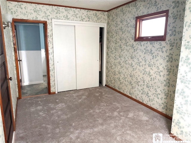 11 Elm St, Hanover, NY 14136 - unfurnished bedroom with ornamental molding, a closet, wallpapered walls, and carpet