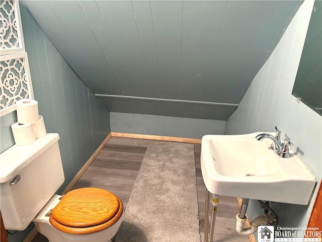 11 Elm St, Hanover, NY 14136 - half bath with wood finished floors, a decorative wall, and lofted ceiling