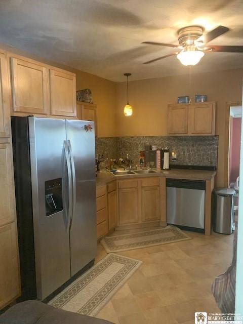 6 Dean St, Randolph, NY 14772 - kitchen featuring appliances with stainless steel finishes, light brown cabinets, ceiling fan, backsplash, and decorative light fixtures