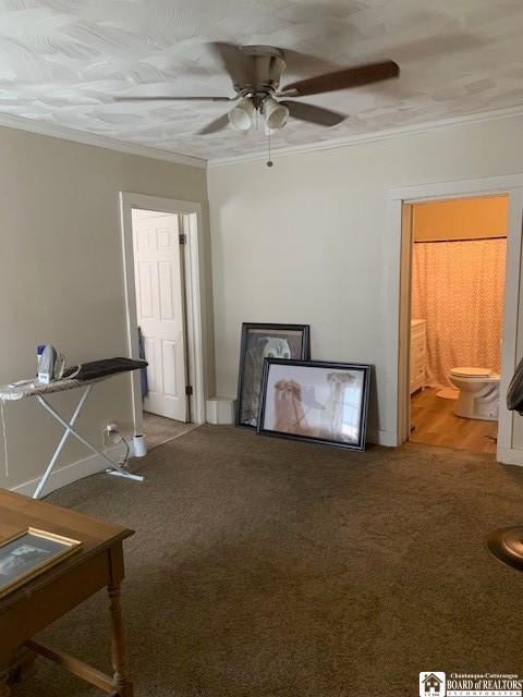 6 Dean St, Randolph, NY 14772 - unfurnished living room featuring crown molding, ceiling fan, and carpet