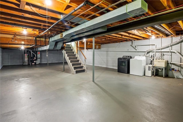 42 Twin Circle Dr, Gates, NY 14624 - unfinished basement featuring washing machine and clothes dryer, stairway, water heater, and heating unit