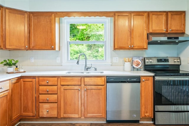 42 Twin Circle Dr, Gates, NY 14624 - kitchen featuring appliances with stainless steel finishes, ventilation hood, light countertops, and backsplash