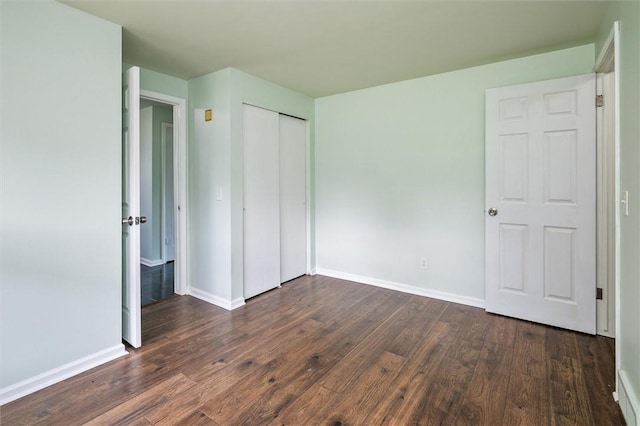 42 Twin Circle Dr, Gates, NY 14624 - unfurnished bedroom with dark wood-style flooring and a closet