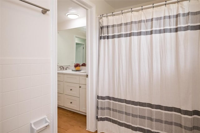 42 Twin Circle Dr, Gates, NY 14624 - bathroom featuring tile walls, vanity, wood finished floors, and a shower with curtain