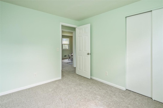 42 Twin Circle Dr, Gates, NY 14624 - unfurnished bedroom featuring light colored carpet and a closet