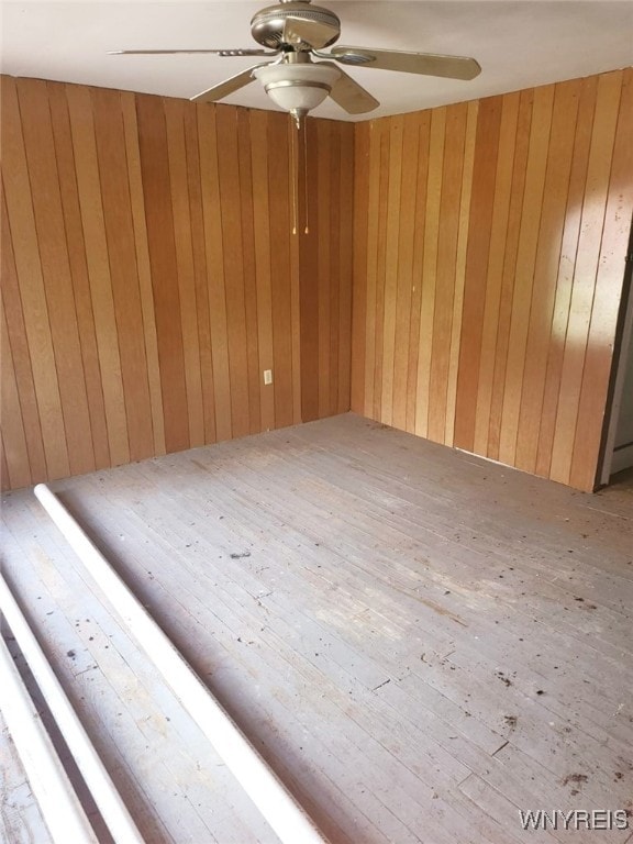 550 Spaulding St, Elmira City, NY 14904 - empty room featuring ceiling fan and wooden walls
