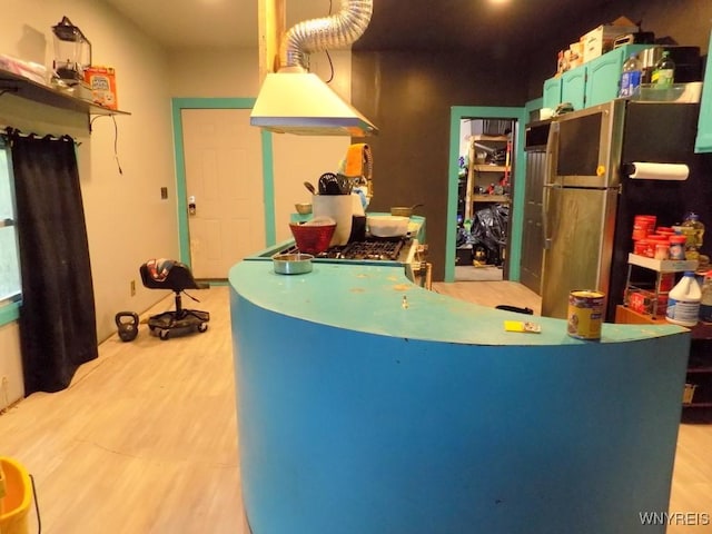 218 Strauss St, Buffalo, NY 14211 - kitchen featuring freestanding refrigerator, light wood-type flooring, and ventilation hood