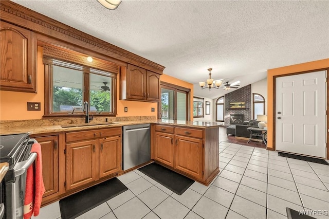 6103 Reger Dr, Lockport Town, NY 14094 - kitchen featuring appliances with stainless steel finishes, a peninsula, a chandelier, lofted ceiling, and brown cabinets