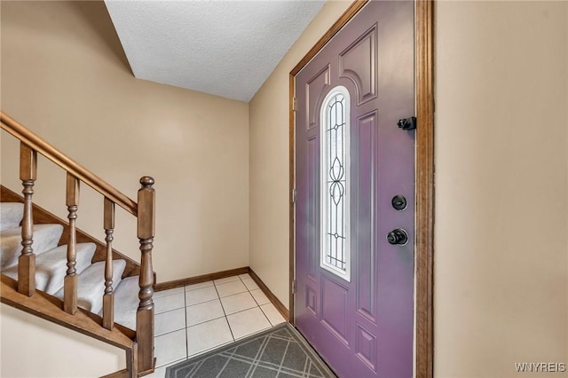 6103 Reger Dr, Lockport Town, NY 14094 - foyer with a textured ceiling, stairway, and light tile patterned floors