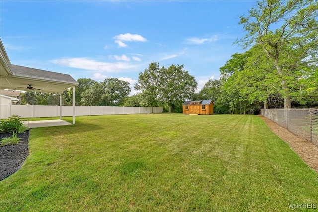 6103 Reger Dr, Lockport Town, NY 14094 - fenced backyard with a shed, a ceiling fan, and a patio area