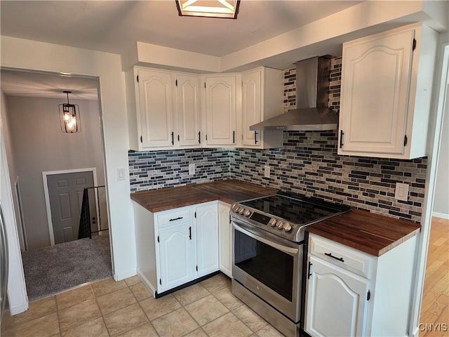 3978 Thrush Ln, Clay, NY 13090 - kitchen with wall chimney exhaust hood, stainless steel electric stove, butcher block counters, and white cabinets