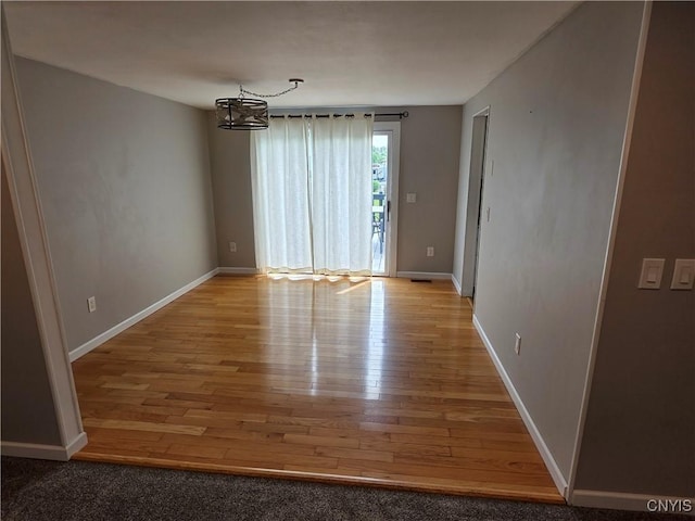 3978 Thrush Ln, Clay, NY 13090 - empty room with light wood-type flooring and a chandelier
