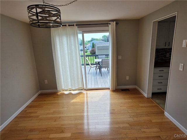 3978 Thrush Ln, Clay, NY 13090 - unfurnished dining area featuring a chandelier and light wood-style floors