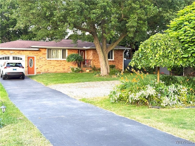 653 S S Colony Rd, Grand Island, NY 14072 - view of front facade with a garage, driveway, brick siding, and a front lawn