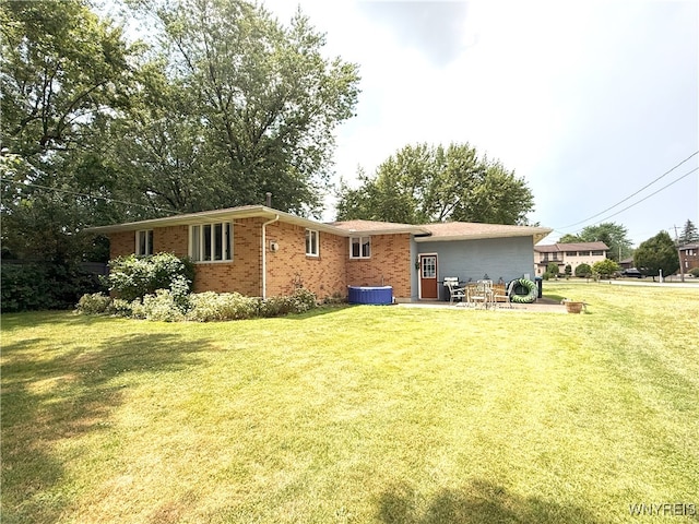 653 S S Colony Rd, Grand Island, NY 14072 - rear view of house featuring a lawn, brick siding, and a patio