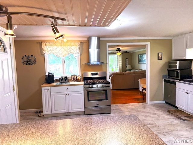 653 S S Colony Rd, Grand Island, NY 14072 - kitchen with appliances with stainless steel finishes, wall chimney range hood, white cabinets, ceiling fan, and crown molding