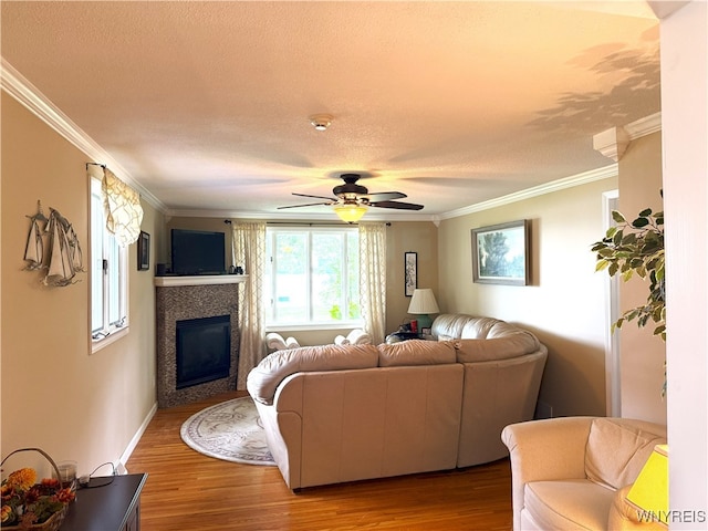 653 S S Colony Rd, Grand Island, NY 14072 - living room with crown molding, wood finished floors, a tile fireplace, ceiling fan, and a textured ceiling
