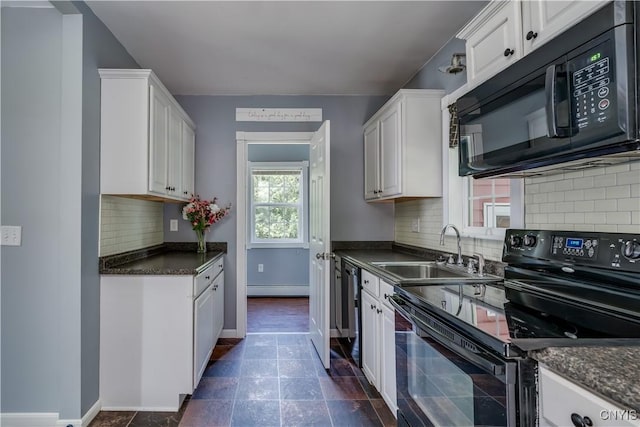 35095 State Route 3, Wilna, NY 13619 - kitchen featuring black appliances, a baseboard heating unit, dark countertops, white cabinets, and backsplash
