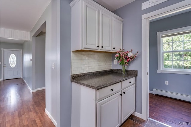 35095 State Route 3, Wilna, NY 13619 - kitchen with dark countertops, white cabinets, decorative backsplash, dark wood-type flooring, and baseboard heating