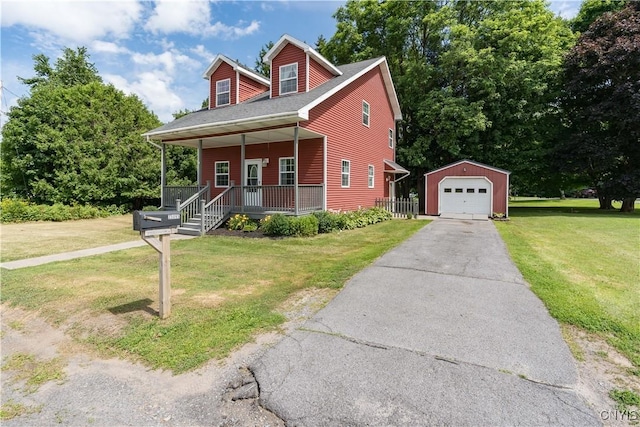 35095 State Route 3, Wilna, NY 13619 - view of front of property with a detached garage, covered porch, asphalt driveway, an outbuilding, and a front yard