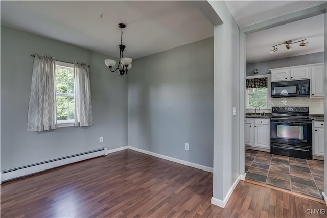 35095 State Route 3, Wilna, NY 13619 - unfurnished dining area with a baseboard heating unit, a chandelier, and dark wood-type flooring