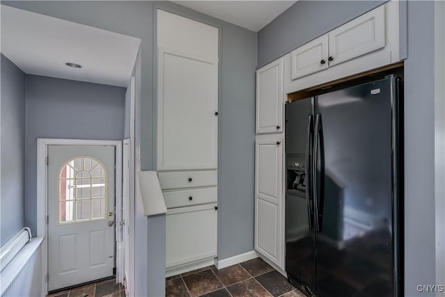 35095 State Route 3, Wilna, NY 13619 - kitchen featuring black refrigerator with ice dispenser, white cabinets, and stone tile flooring