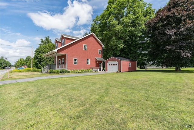 35095 State Route 3, Wilna, NY 13619 - view of home's exterior featuring an outbuilding, covered porch, a detached garage, a yard, and driveway
