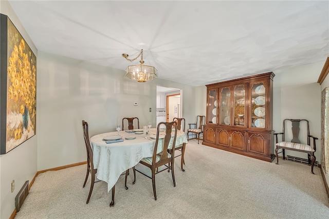 129 Patrice, Amherst, NY 14221 - dining space with carpet floors and a chandelier