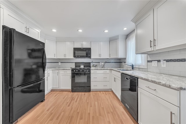129 Patrice, Amherst, NY 14221 - kitchen with black appliances, backsplash, light wood-style floors, white cabinetry, and recessed lighting