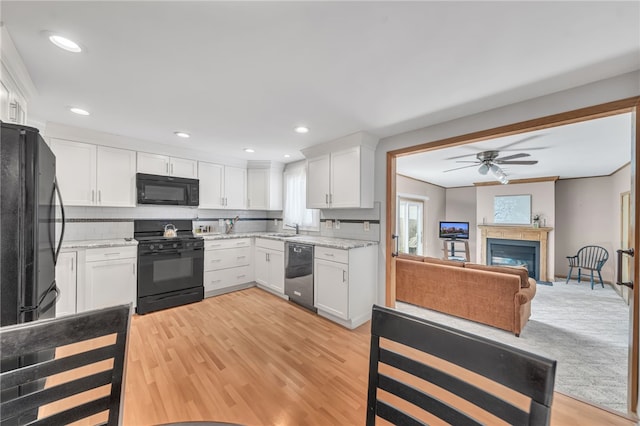 129 Patrice, Amherst, NY 14221 - kitchen with black appliances, ceiling fan, white cabinets, open floor plan, and light stone countertops