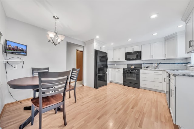 129 Patrice, Amherst, NY 14221 - kitchen featuring black appliances, decorative backsplash, a chandelier, light wood-style floors, and recessed lighting