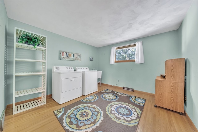 129 Patrice, Amherst, NY 14221 - washroom featuring wood finished floors and washer and dryer