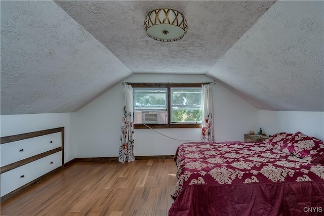 13051 State Route 3, Hounsfield, NY 13685 - bedroom featuring a textured ceiling, wood finished floors, lofted ceiling, and cooling unit