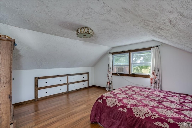 13051 State Route 3, Hounsfield, NY 13685 - bedroom featuring a textured ceiling, wood finished floors, vaulted ceiling, and cooling unit