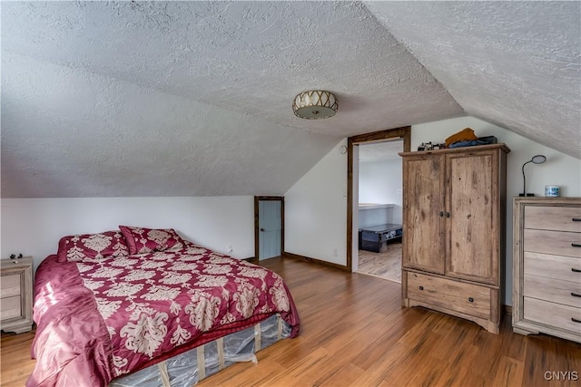 13051 State Route 3, Hounsfield, NY 13685 - bedroom with a textured ceiling, wood finished floors, and vaulted ceiling
