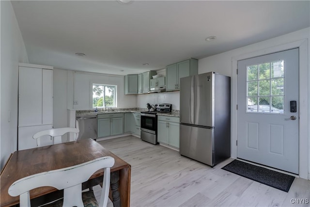 13051 State Route 3, Hounsfield, NY 13685 - kitchen with appliances with stainless steel finishes, under cabinet range hood, and light wood finished floors