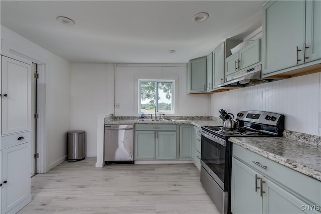 13051 State Route 3, Hounsfield, NY 13685 - kitchen with appliances with stainless steel finishes, under cabinet range hood, light wood-type flooring, and light stone countertops