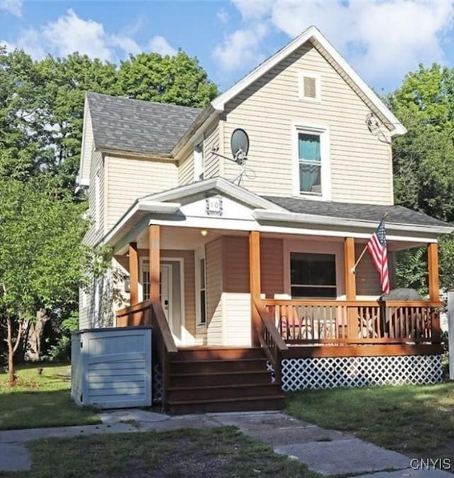 10 N 8th St, Fulton, NY 13069 - view of front of home featuring a porch, a shingled roof, and a front lawn